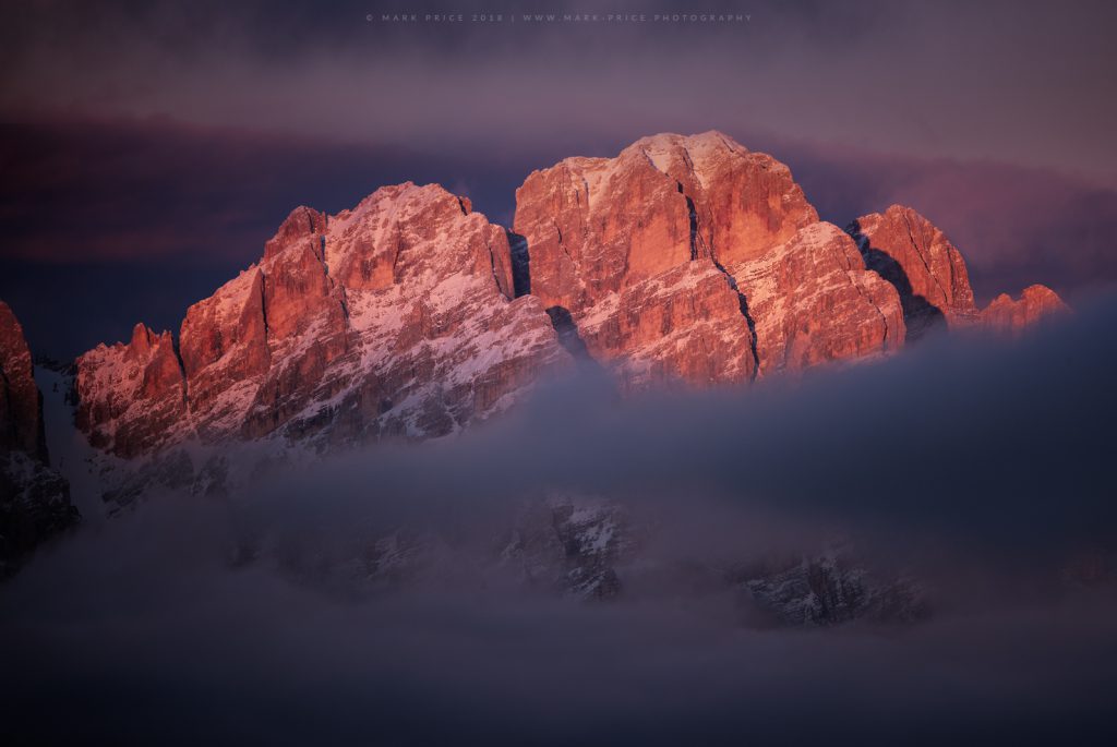 Evening light illuminates a peak above Cortina D'Ampezzo in Italy