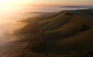 The South Downs at sunrise as the summer mists return to Sussex