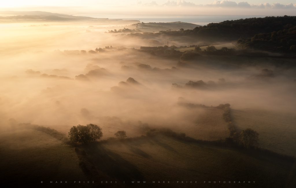 A wave of mist wraps the Dorset Landscape