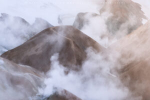 A small peak emerges from the sulphuric smoke in the central highlands, Iceland