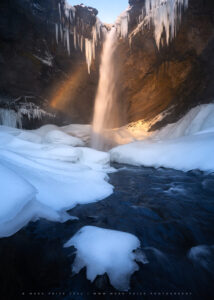 The end of the day brings light and rainbows to the hidden waterfall on Iceland..