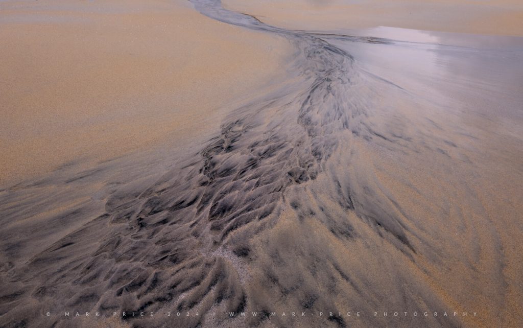Sand patterns creating art - Lewis 2024